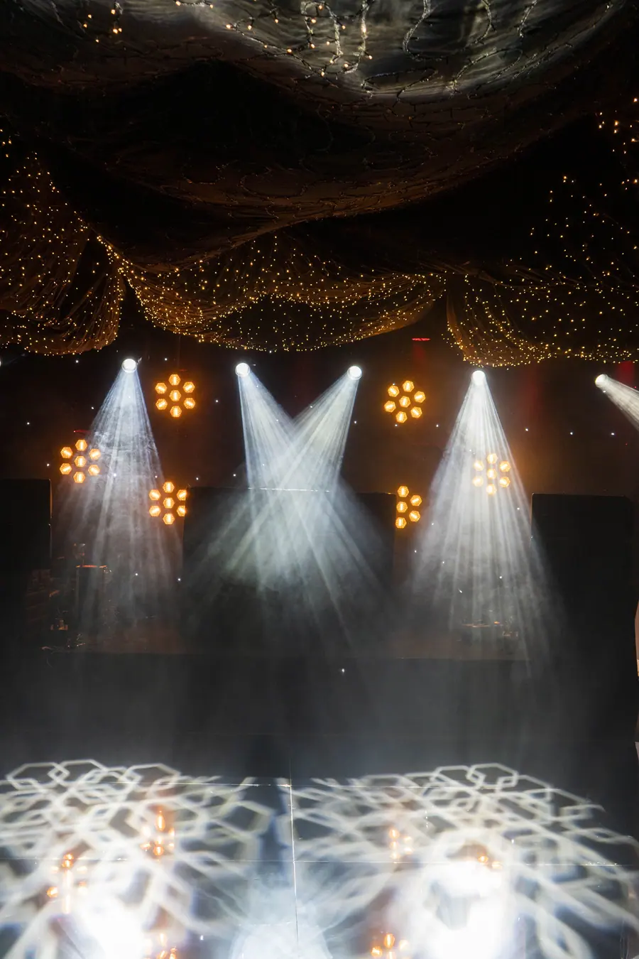Stage lighting with spotlight beams over a performance floor