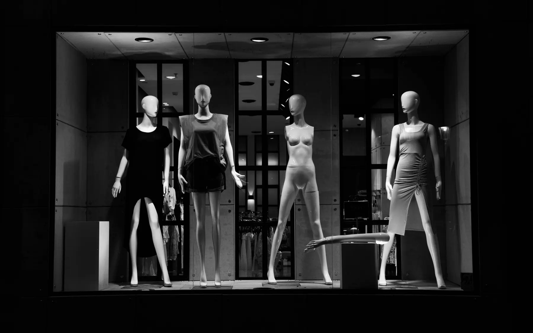 Black-and-white fashion window display with mannequins