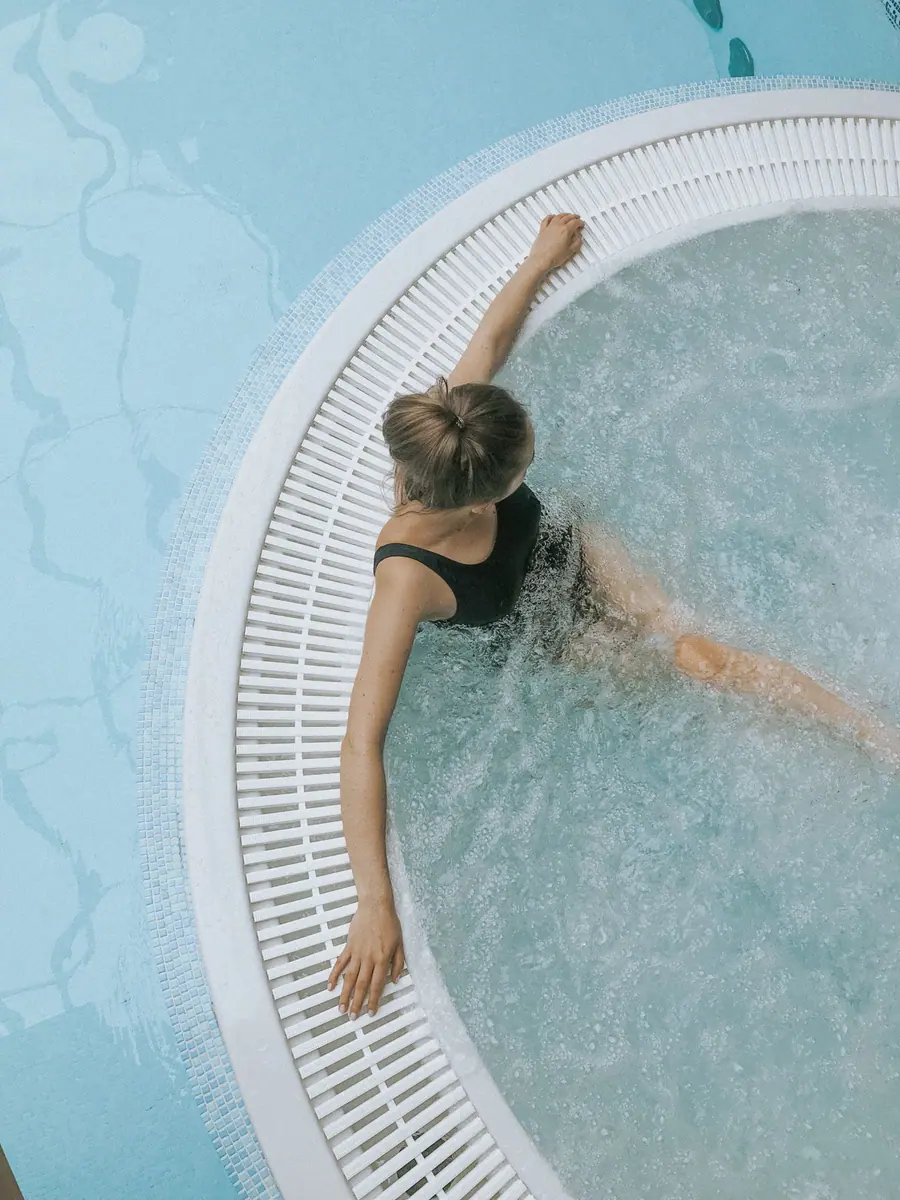 Woman relaxing in a spa pool, seen from above